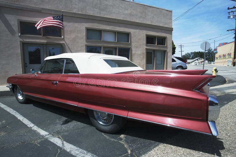 Vintage Cadilac and US Flag parked in front of Saddle Shop, Oak View, California, USA