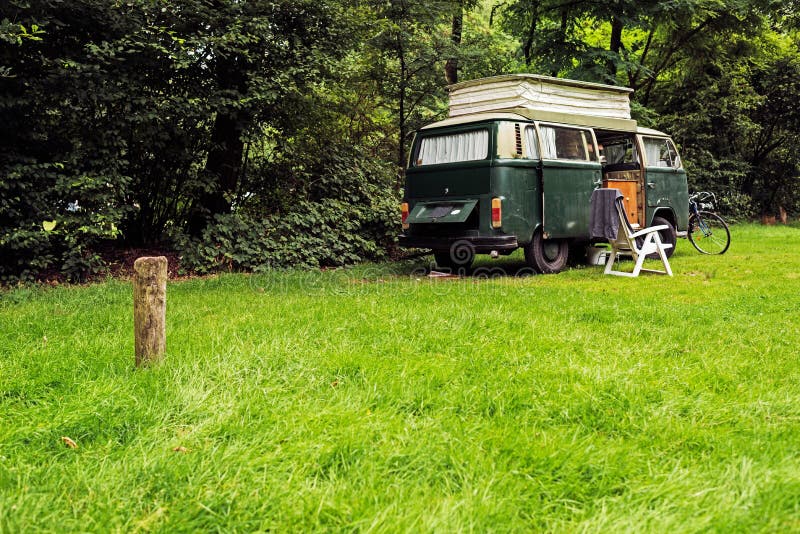 Vintage Camping Van on Meadow in Forest.