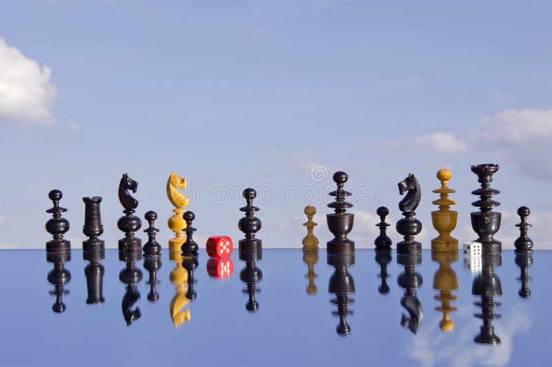 Vintage chessmans and red dice on mirror