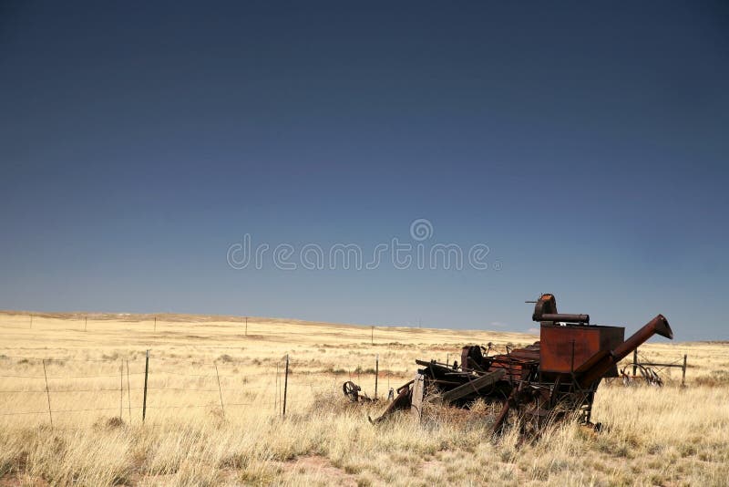Vintage combine harvester and old field