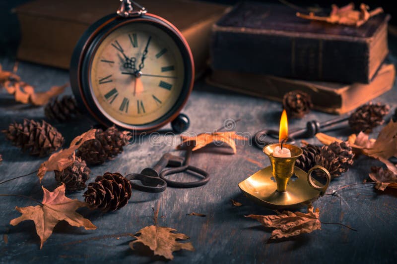 Vintage still life with antique books, clock and candle. Halloween and occult concept. Vintage still life with antique books, clock and candle. Halloween and occult concept.