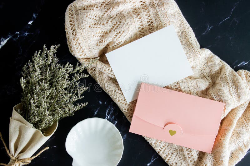 Vintage concept with natural flower, letter and envelope with black marble background. royalty free stock images