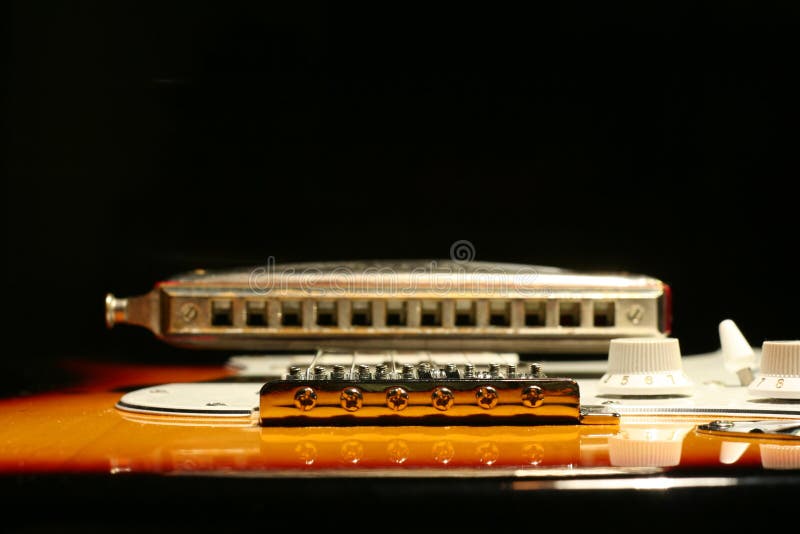Vintage Electric Guitar With Harmonica On Black Background Stock Image