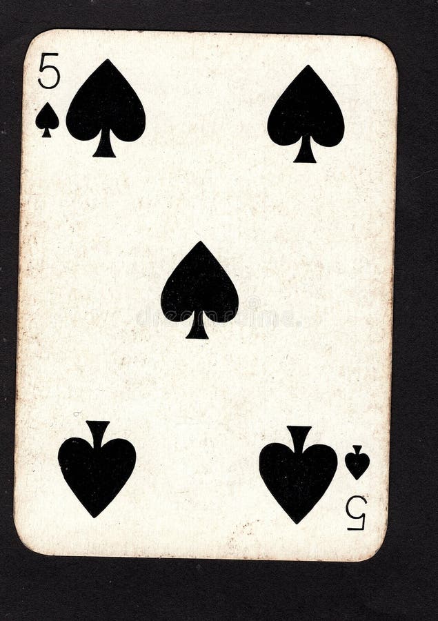 A vintage five of spades playing card on a black background. royalty free stock photography