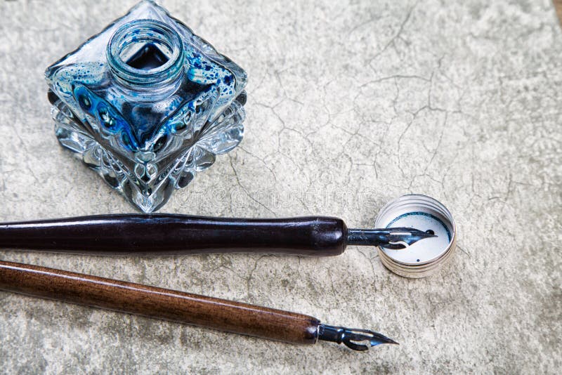 Vintage fountain pens and ink on a retro stock photography