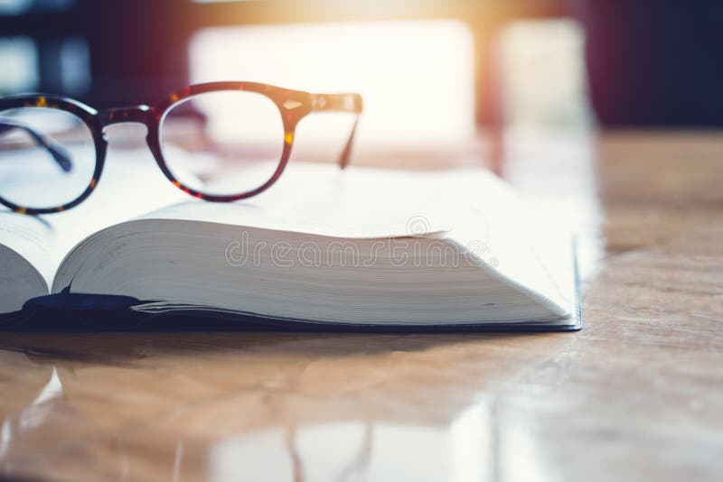 Vintage glasses,on books stack in public library book, Studying examining. Tutor books with friends