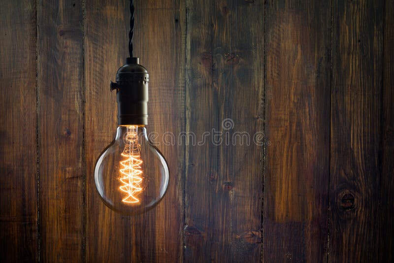 Vintage incandescent Edison type bulb on wooden background royalty free stock photography Vintage incandescent Edison type bulb on wooden background royalty free stock photography