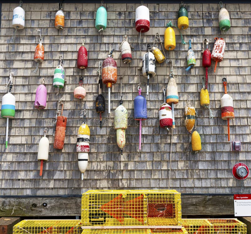 Vintage Lobster Buoys Hanging on a Weathered Wall with Yellow