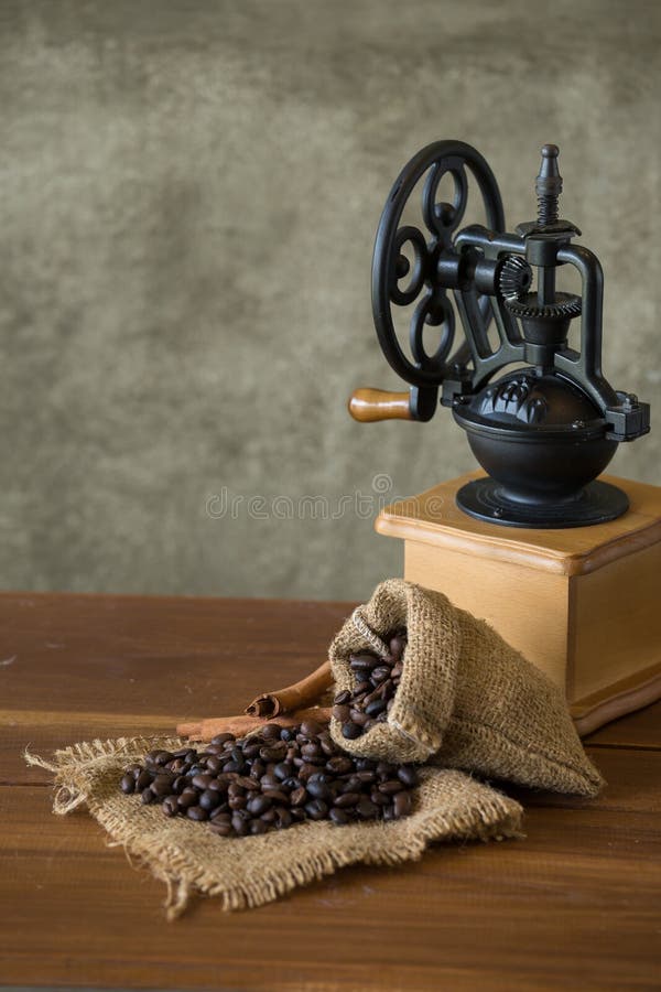 Vintage Manual Coffee Grinder with Coffee Beans and Cup Stock Image