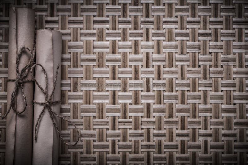 Vintage medieval parchment on wicker wooden surface stock photo