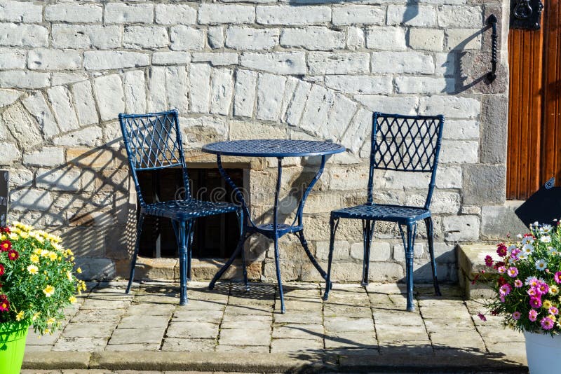 Vintage metal bistro table and chairs set in outdoor cafe