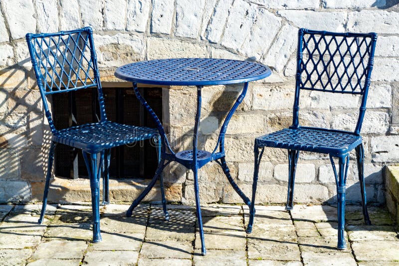 Vintage metal bistro table and chairs set in outdoor cafe