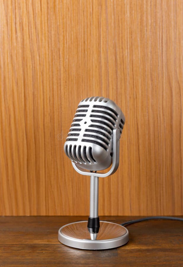 The Vintage Microphone Close Up Image on Wood Background Stock Photo