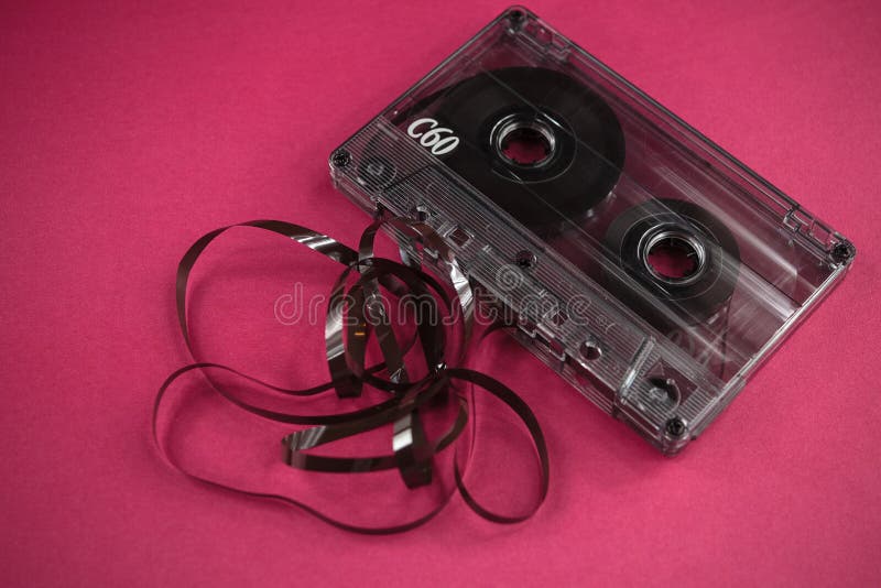 vintage old film music cassette on a pink background, background music stock photography