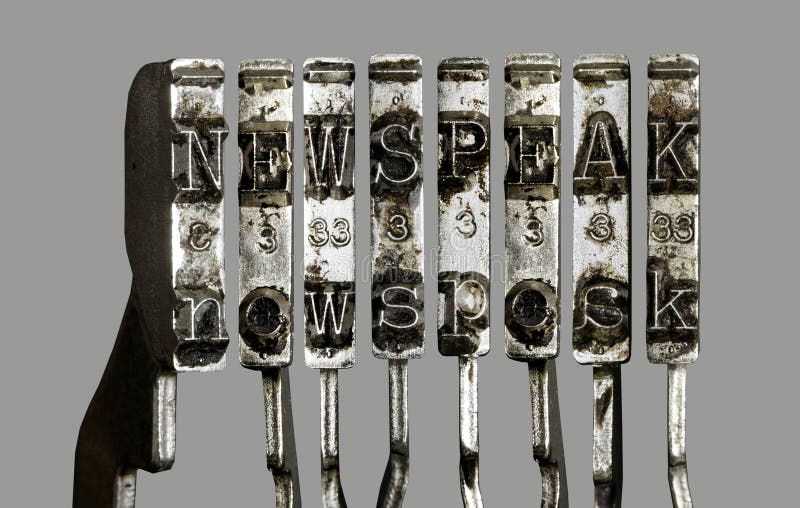 Vintage old typewriter hammers newspeak. Vintage old typewriter hammers  with the word  newspeak