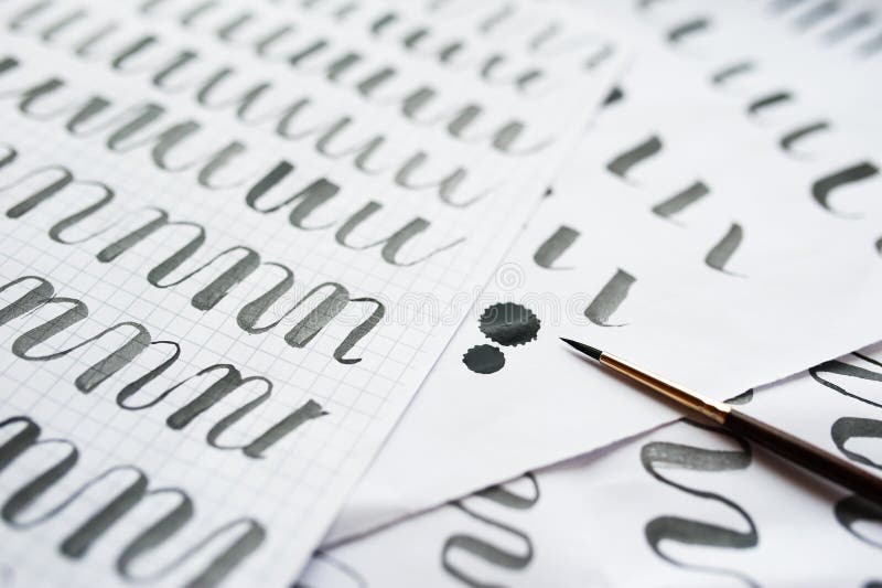 Antique Calligraphy Pens And Ink Blots With Fancy Writing On Paper