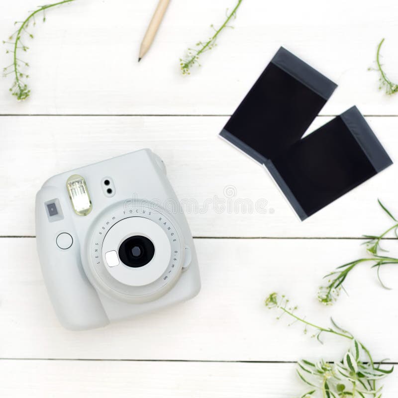 Vintage photo camera on white background with photo cards. Polaroid camera. Instax white camera. Flat lay. stock photo Vintage photo camera on white background with photo cards. Polaroid camera. Instax white camera. Flat lay. stock photo