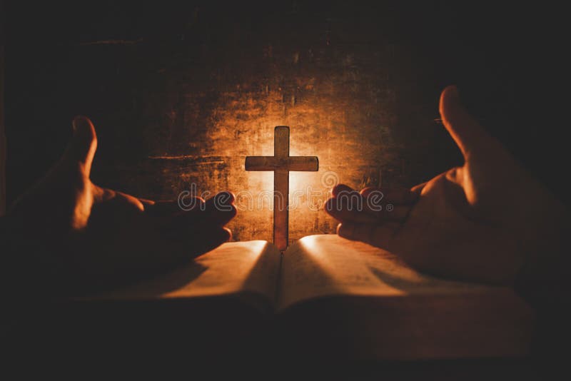 Vintage photo of hand with Bible praying , Hands folded in prayer on a Holy Bible