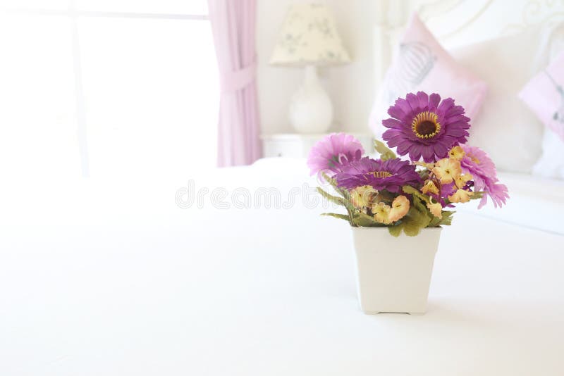 Vintage Pink Artificial Flowers on a Table in the White Bedroom. Stock