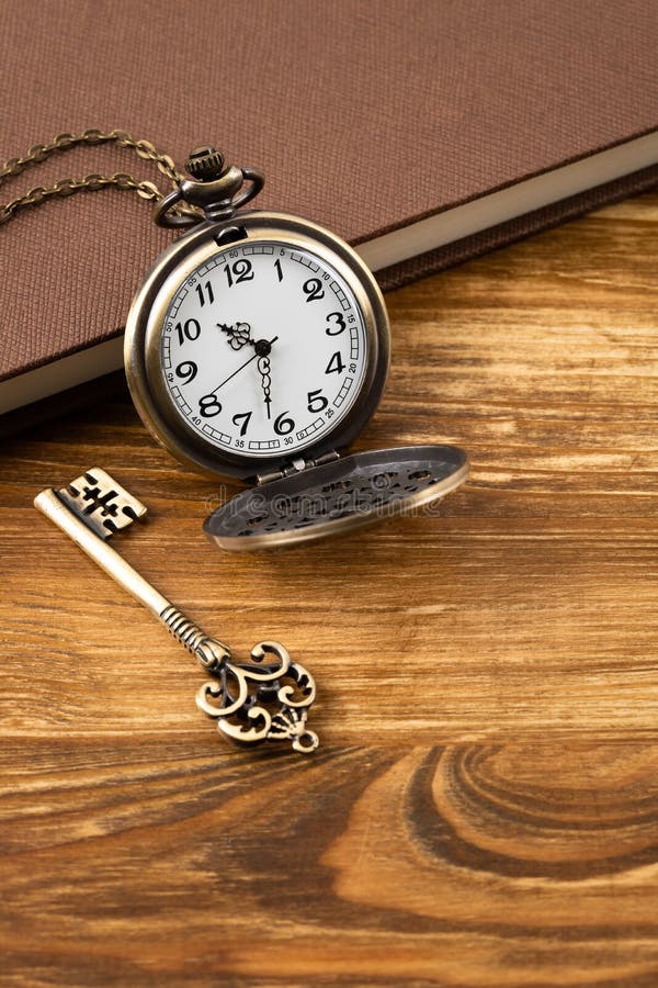 Vintage Pocket Watch Clock with Key and Book on Wooden Background Stock  Image - Image of classic, knowledge: 152383373