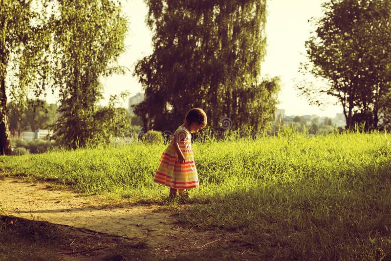 vintage portrait of cute Little girl walk on a summer field