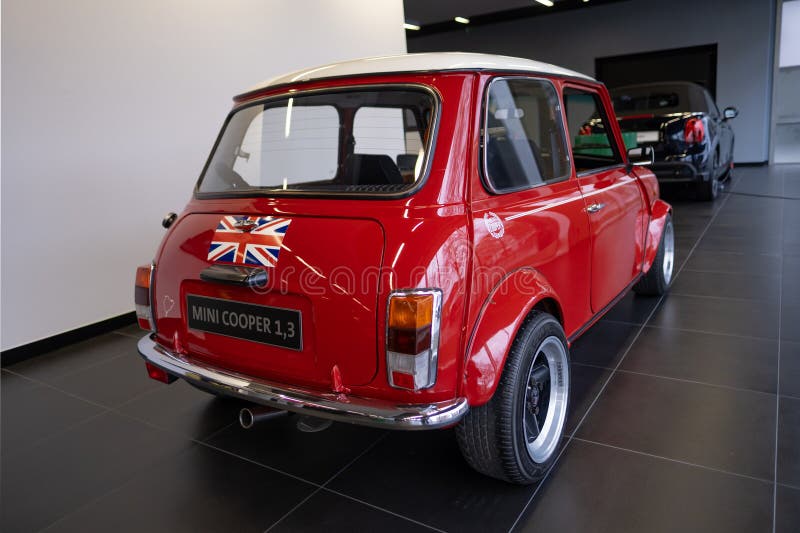 vintage Red Classic Rover MINI Cooper 1.3 Oldtimer in showroom, iconic design technology, retro-style, Automotive Industry, Frankfurt, Germany - January 21, 2024. vintage Red Classic Rover MINI Cooper 1.3 Oldtimer in showroom, iconic design technology, retro-style, Automotive Industry, Frankfurt, Germany - January 21, 2024