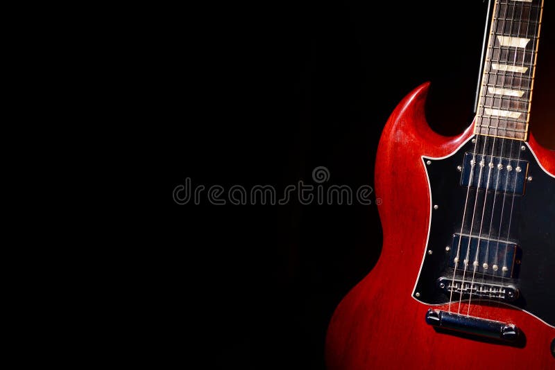Vintage red electric guitar on moody dark background royalty free stock image