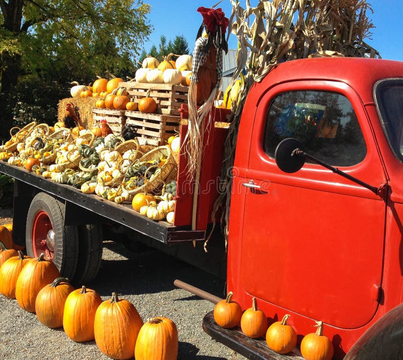 Vintage Red Farm Truck with Fall Harvest Gourds