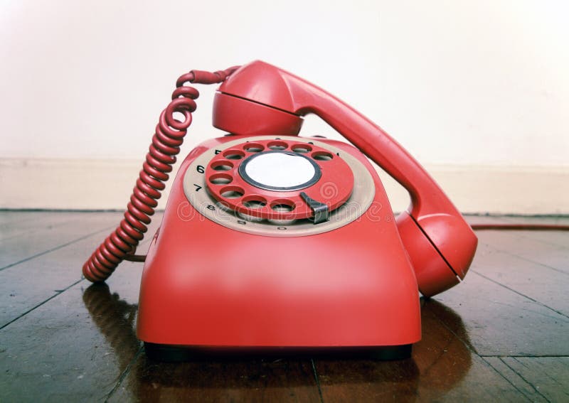 Vintage red phone off the hook close up