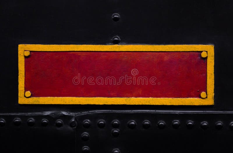 Vintage red and yellow metal plate on the old train. Textured background. Close shot. stock photography.