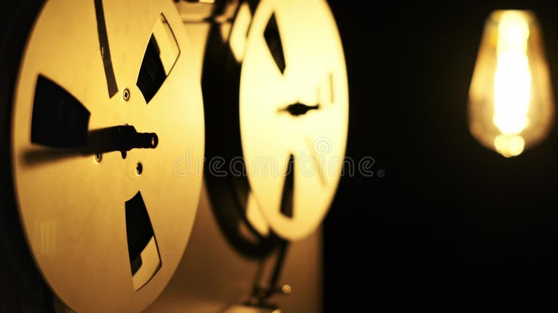 Vintage Reel-to-Reel Player Spinning Spools in Warm Light stock footage