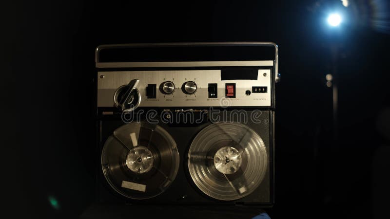 Vintage Reel-to-Reel Tape Player Spinning in Dark Studio stock video