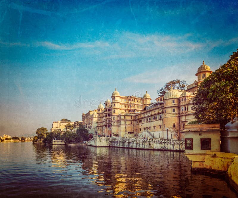 Vintage retro hipster style travel image of romantic India luxury tourism concept background - Udaipur City Palace and Lake Pichola. Udaipur, Rajasthan, India with grunge texture overlaid. Vintage retro hipster style travel image of romantic India luxury tourism concept background - Udaipur City Palace and Lake Pichola. Udaipur, Rajasthan, India with grunge texture overlaid