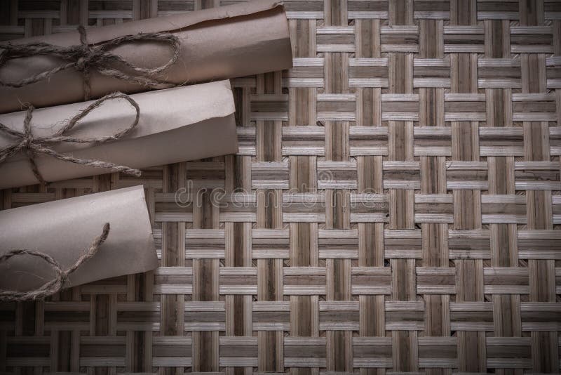 Vintage rolled parchment on woven wooden surface royalty free stock image