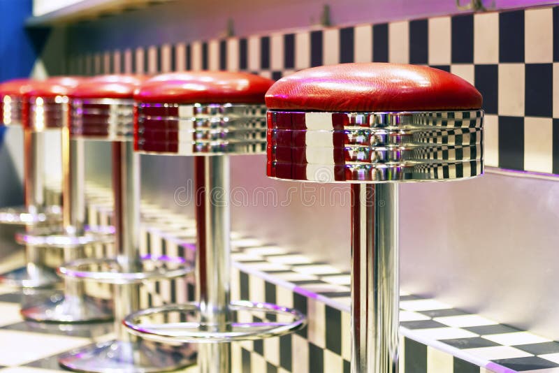 Vintage Row of metal bar stools, interior, red metal chairs near