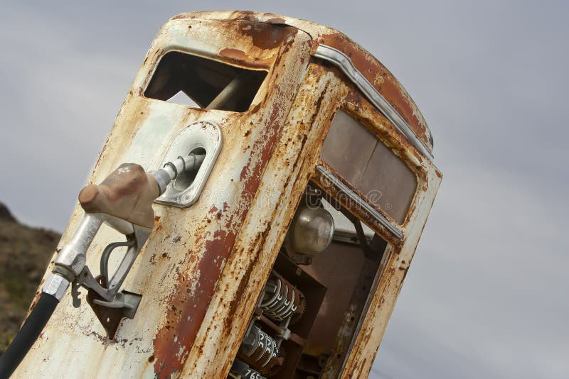 A vintage rusted gas pump abandoned in the desert