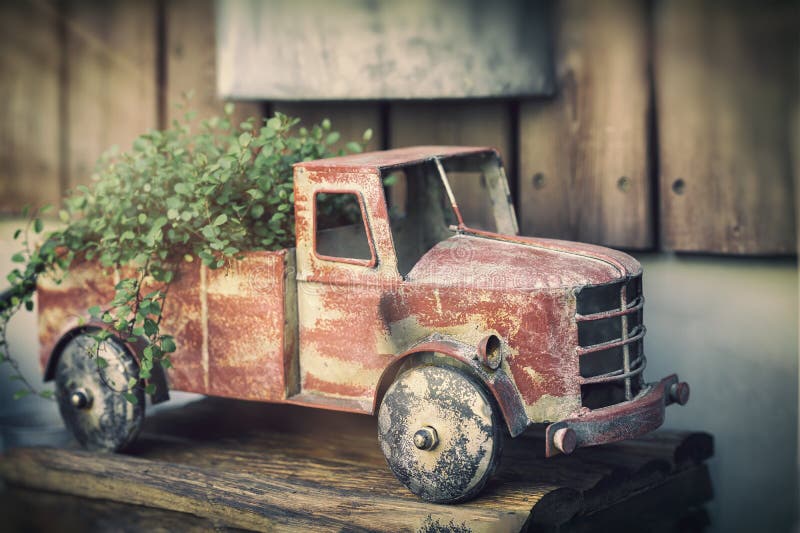 Vintage rusty toy car dump truck with plants, garden decor