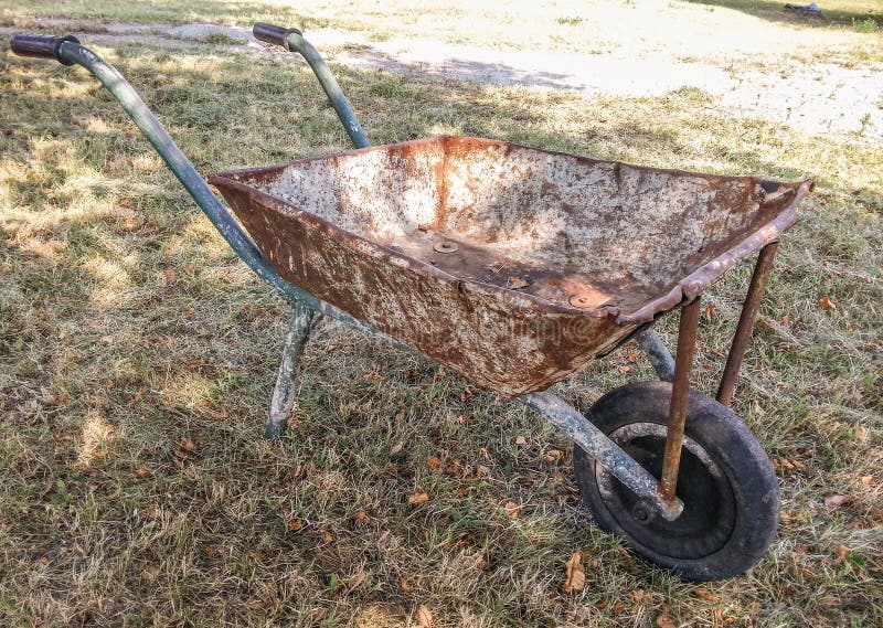 Vintage rusty wheelbarrow editorial photography. Image of traditional
