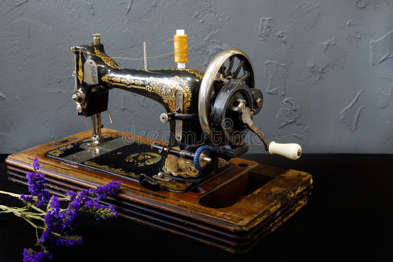 Vintage sewing machine is standing on the white table royalty free stock photography