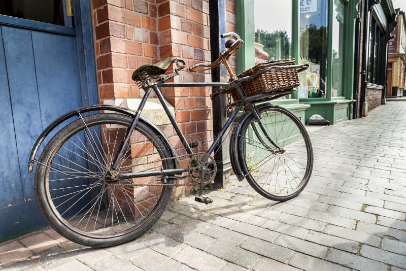Vintage shop bicycle with wicker basket on the front.