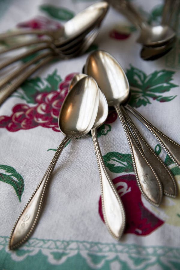 Vintage silver spoons on an antique tablecloth