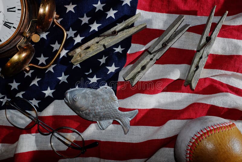 vintage still life, the American flag, old alarm clock, glasses, baseball, clothespins, fish