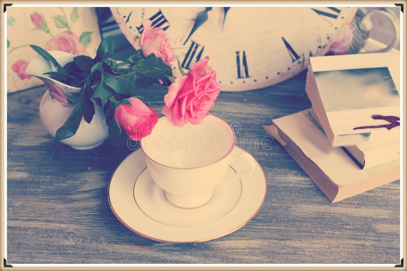 Vintage still life with roses cup and books