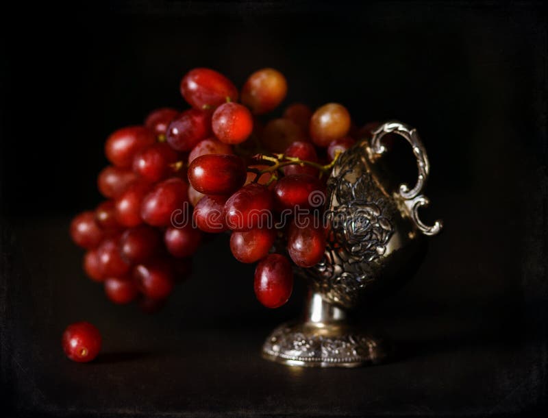 Vintage style image of red grapes in an antique bowl