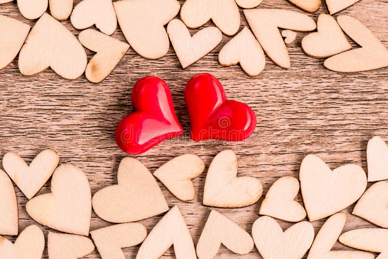 Vintage style of two red hearts with Wooden hearts on a wooden