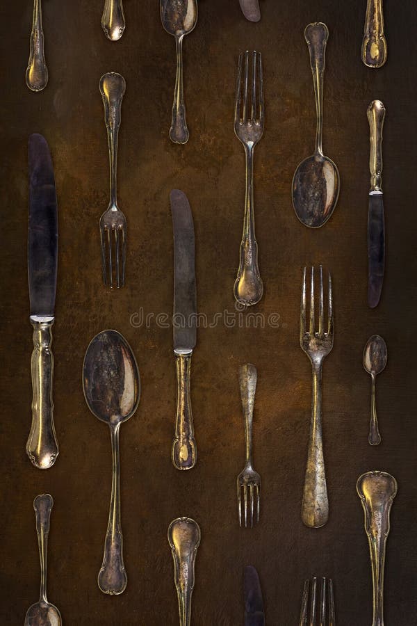 Vintage styled image of old forks, knives and spoons in a repetitive pattern royalty free stock photo