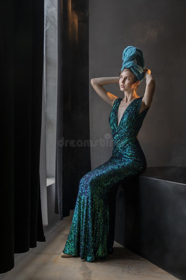 Beautiful Woman Sitting On The Edge Of The Bath Stock