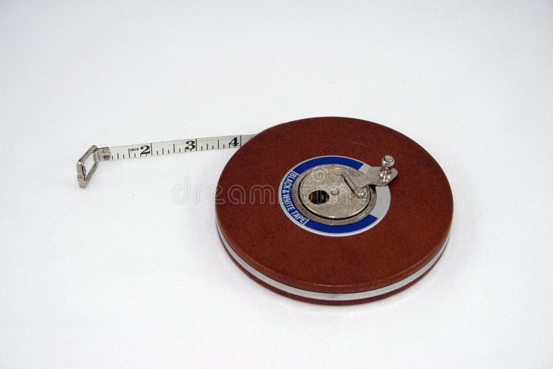 White Tailor Measuring Tape On A Wood Table Stock Photo - Download