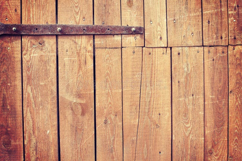 Vintage toned old wooden barn door background