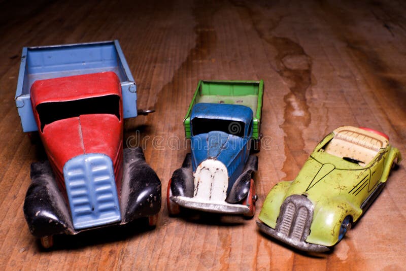 Vintage Toy Cars Lorry Truck And Convertible Car On Brown Wooden Background. Retro Toys For Boys